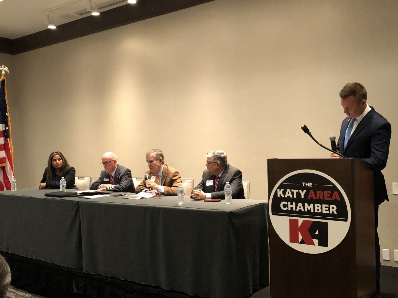 From left, Seelpa Keshvala, Bob Glenn, Zach Hodges and Jay Neal discuss the state of higher education in Katy at a Feb. 17 Katy Area Chamber of Commerce luncheon. Jason Burdine, a financial advisor who serves on the chamber’s education committee, stands at the podium.